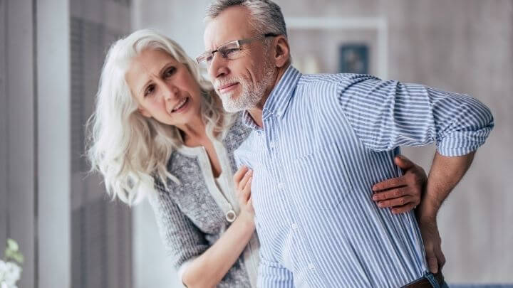 Older woman helping her husband